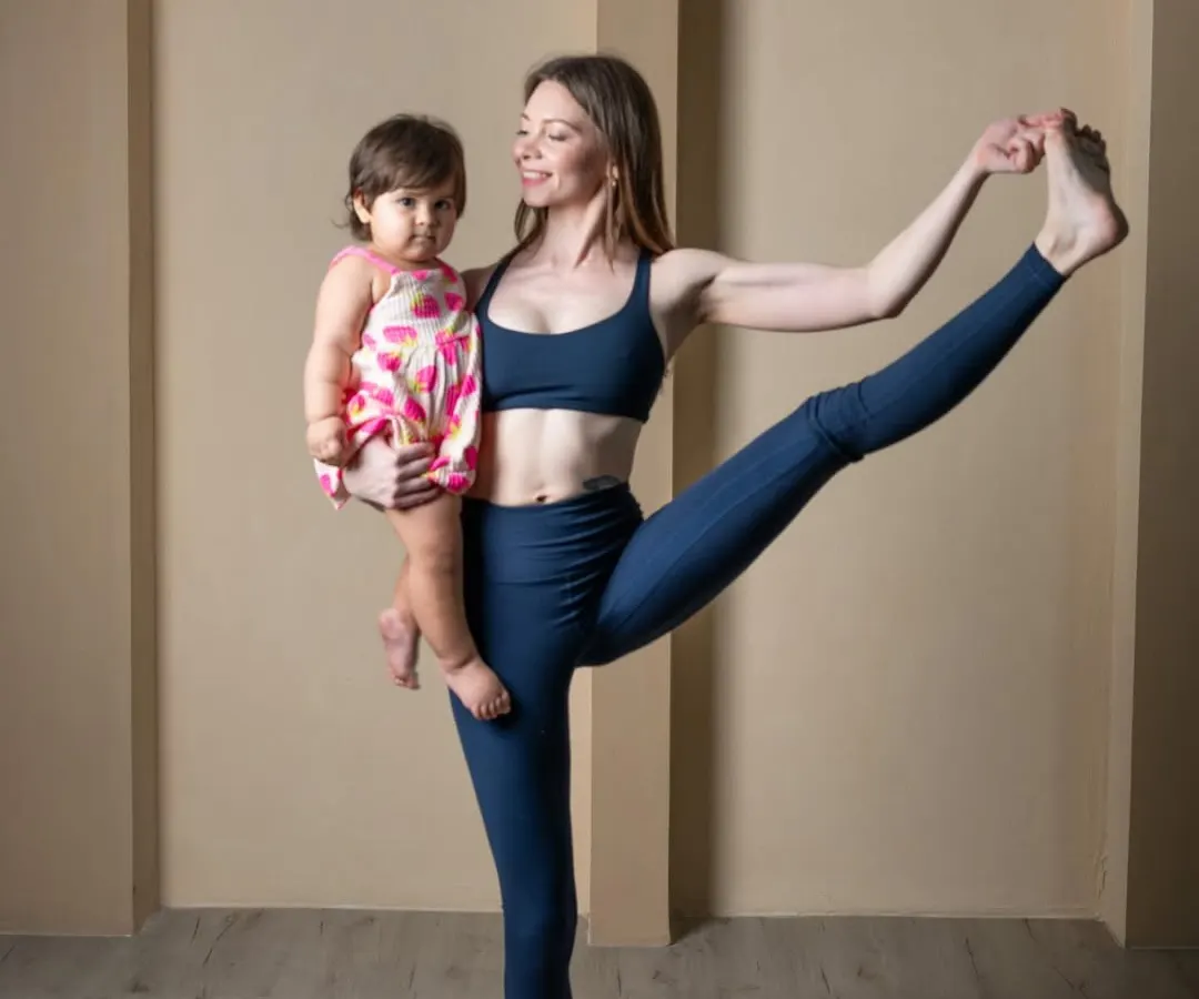 This is what my practice looks like now, and I wouldn't have it any other way. Holding my daughter while in Utthita Hasta Padangusthasana shows how yoga adapts to life. Motherhood has taught me that balance is not just about holding a pose, but about integrating my practice into my life as a new mom.