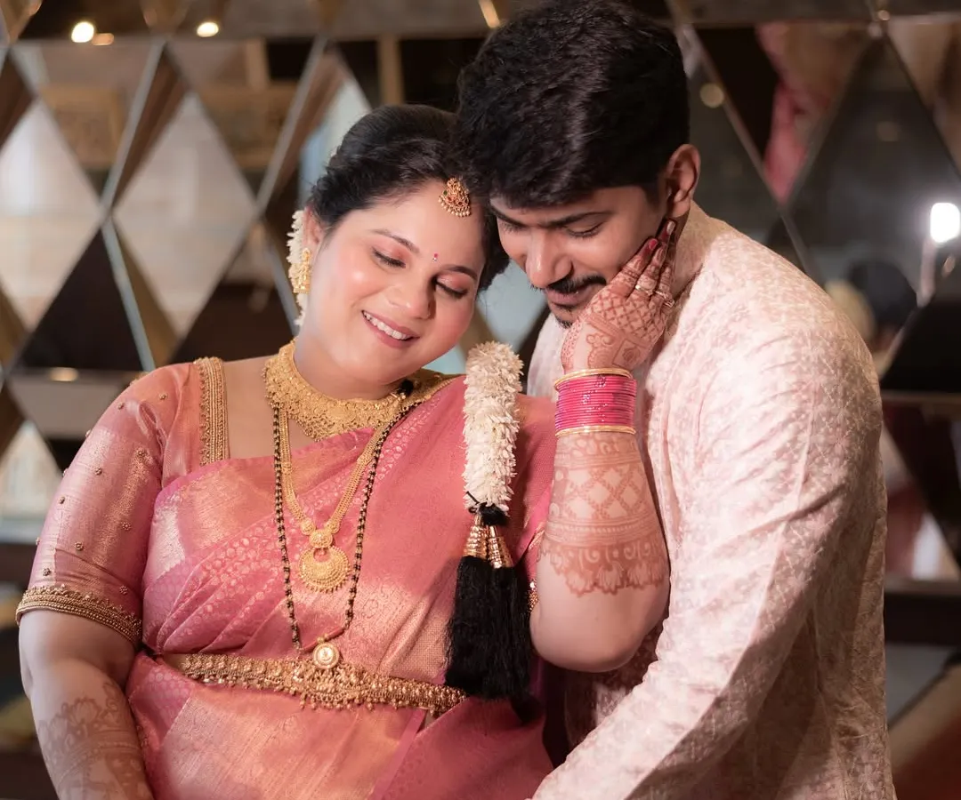 During a traditional Godh Bharai ceremony, there are so many moments of quiet love. Here, the father-to-be gently holds his wife and their baby bump, a beautiful portrait of support and shared joy.