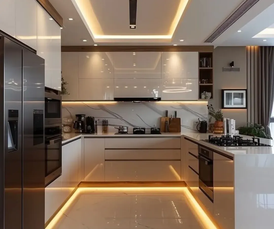 We designed this U-shaped kitchen for maximum efficiency and style, featuring high-gloss white cabinetry and warm wood accents. The integrated under-cabinet and ceiling cove lighting creates a bright, welcoming atmosphere at any time of day.