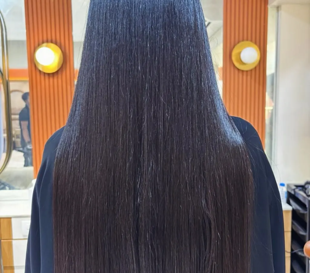 This is the incredible result of my Nanoplastia straightening treatment. Her hair is now glass-like, incredibly smooth, and reflects light beautifully. This service provides a sleek, frizz-free finish without the use of harsh chemicals, focusing on deep hair repair.