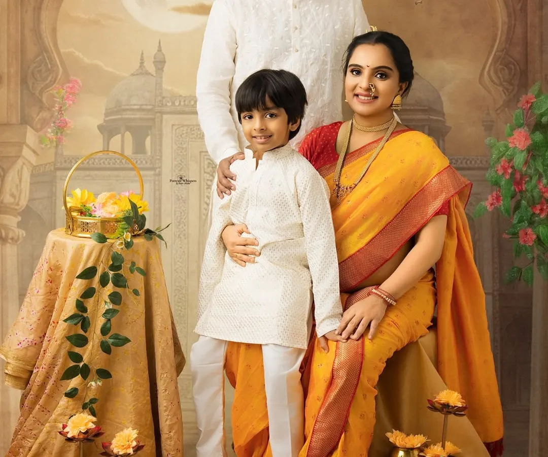 A beautiful family portrait celebrating the arrival of a new member. This painterly style, inspired by traditional Indian art, captures the warmth and love between parents and their soon-to-be older son.