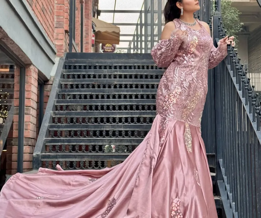 For a glamorous reception or engagement, I styled this client in a stunning pink mermaid gown with a long train. The makeup is kept modern and chic with a sleek ponytail to complement the outfit.