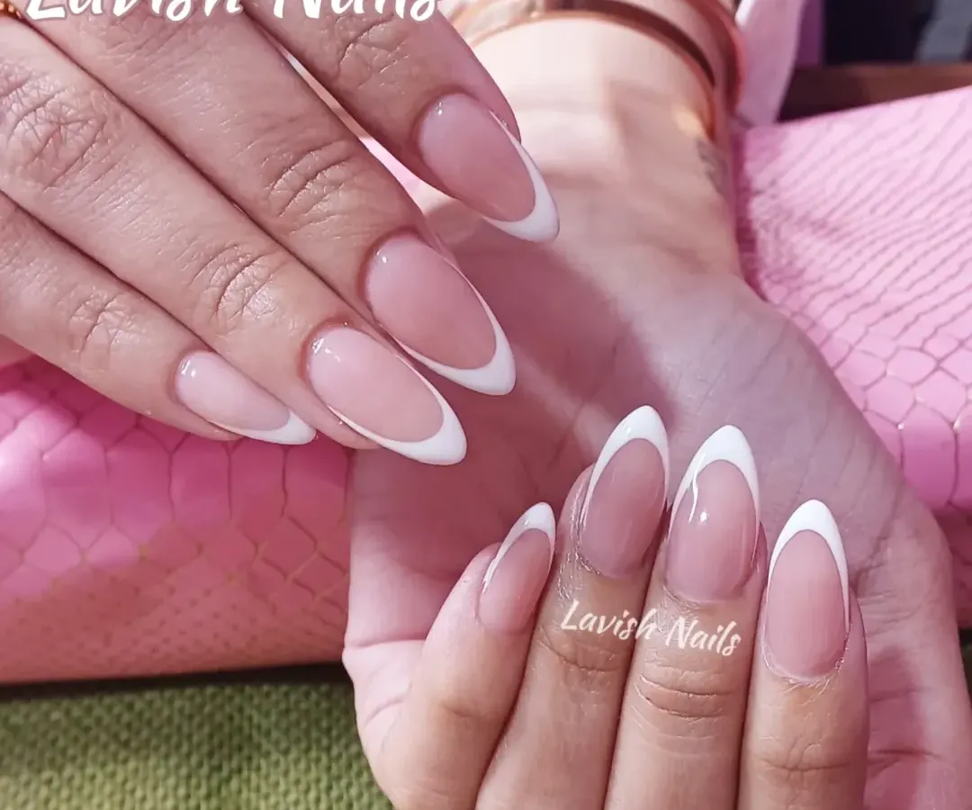 The perfect classic French manicure on elegant, long almond-shaped nails. This design showcases clean lines and a natural-looking pink base for a timeless and sophisticated finish.
