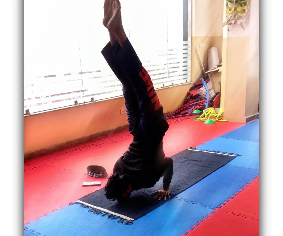 Here I am holding a Ganda Bherundasana, or Chin Stand. This advanced inversion is a great goal to work towards for building exceptional upper body and core strength, showing the level of skill you can achieve with disciplined practice.