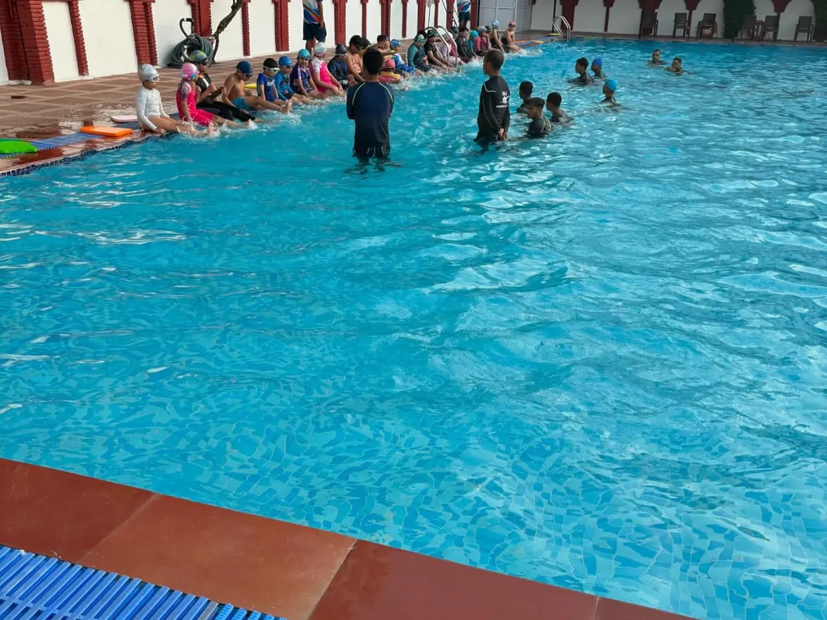 A typical group class at Raj Swimming Academy, with learners of all ages gathered by the poolside. I ensure a structured environment where everyone, from kids to adults, can learn the basics of swimming safely and confidently.
