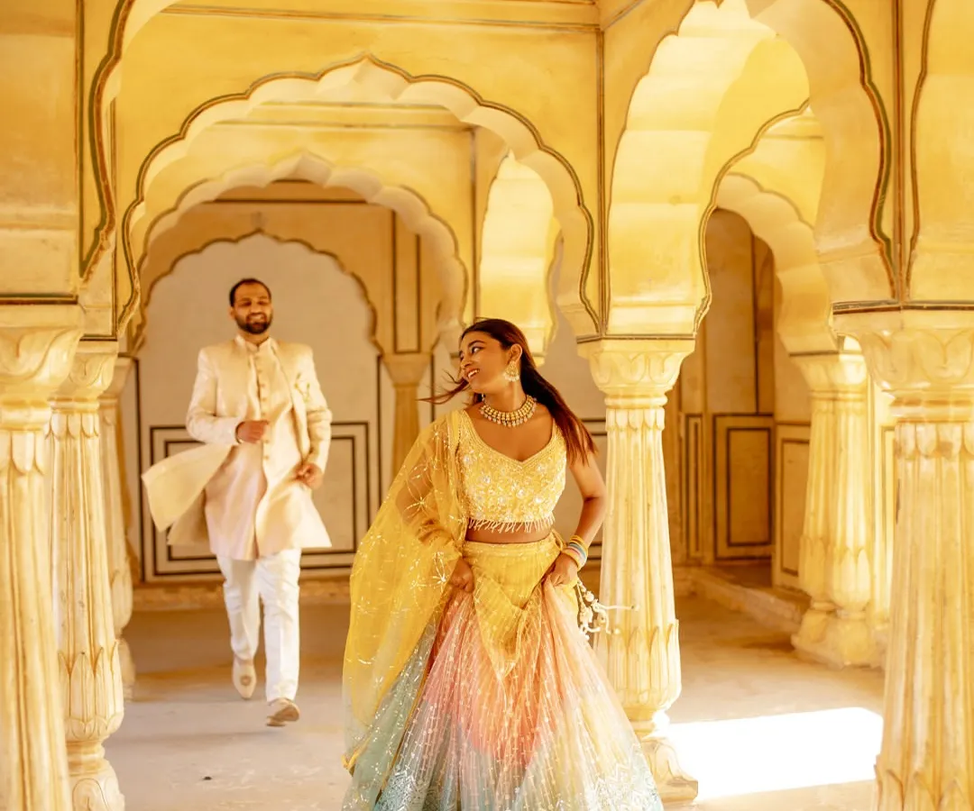 Picture-perfect love deserves a picture-perfect look. I help you create unforgettable pre-wedding shoot memories with coordinated outfits, like this dreamy multi-color lehenga for her and a classic sherwani for him.