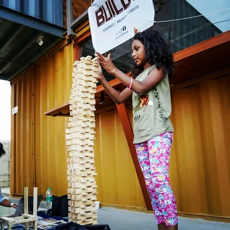 Look at that proud smile! This is the moment it all clicks. After focusing and carefully balancing each plank, this young builder created a tower taller than she is. We see this boost in confidence and sense of achievement in every session, and it's the reason we love what we do.