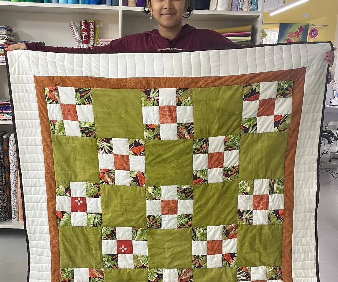It’s a joy to see our youngest creators shine. Here, 12-year-old Shresta proudly displays her very first quilt, a beautiful patchwork project she completed in our kids' sewing workshop.