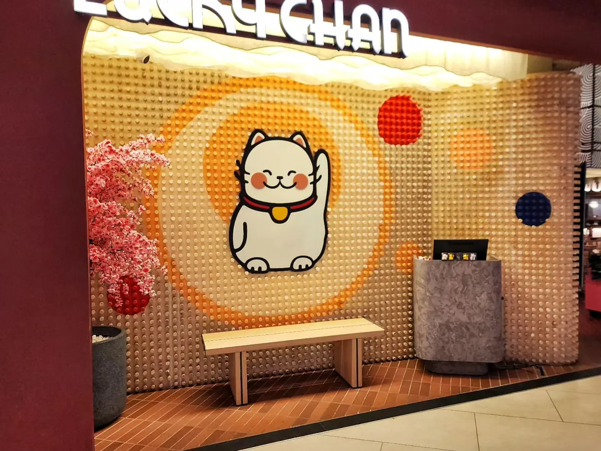 For the entrance of Lucky Chan, we created this textured backdrop for their iconic waving cat logo. The entire piece is made from 1,408 hand-painted wooden pegs, showing how we love to experiment with different materials to create something unique.