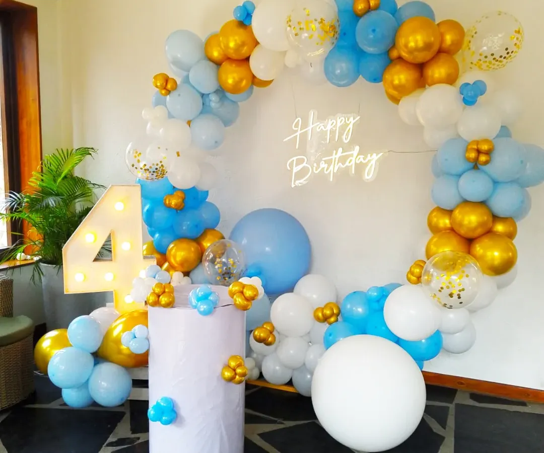 Turning four is a big deal, and we made sure this celebration was picture perfect. We designed this beautiful circular balloon arch with a soft blue, white, and gold palette, complete with a custom neon sign and marquee number, creating a magical photo corner for the little one.