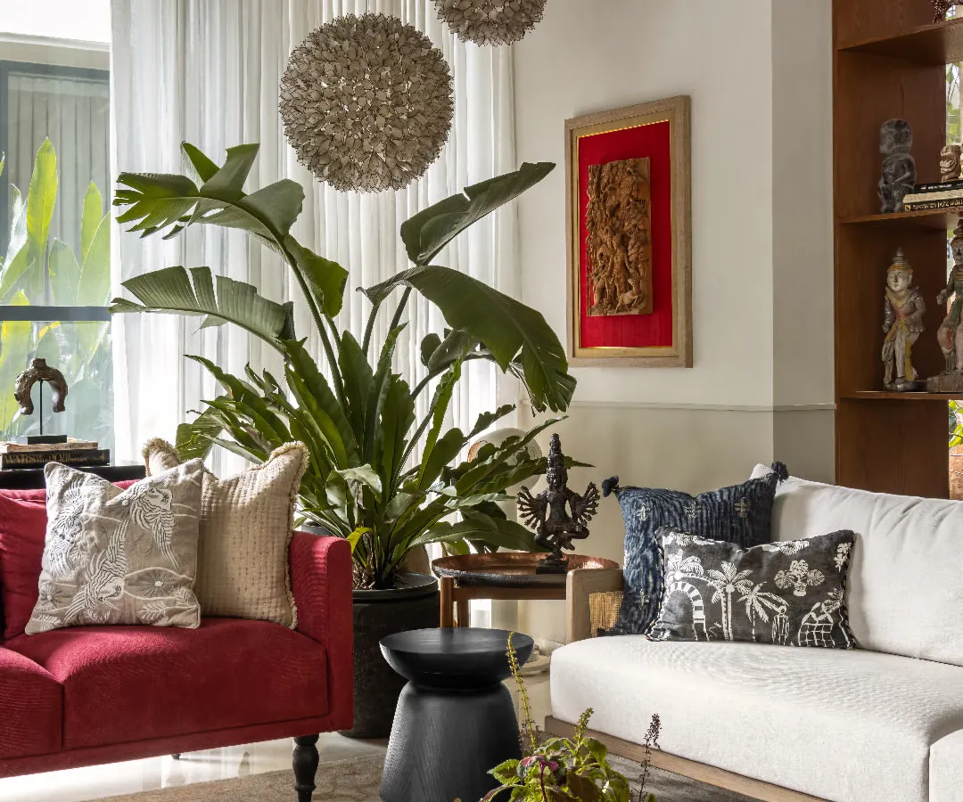 For the living room at The Collector's Retreat, I wanted to create a space that felt both curated and deeply comfortable. The bold red sofa adds a burst of energy, while the layered textures, art pieces from the client's collection, and oversized plants come together to tell a rich, personal story. This is a room designed for lively conversations and quiet afternoons.