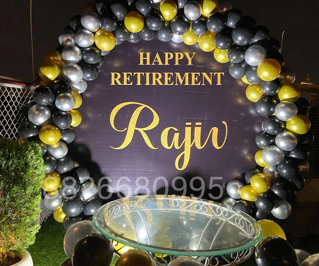 I designed this personalized retirement party decoration for an outdoor event. It features a custom backdrop with the retiree's name and a sophisticated black, gold, and silver balloon arch, perfect for corporate farewells.