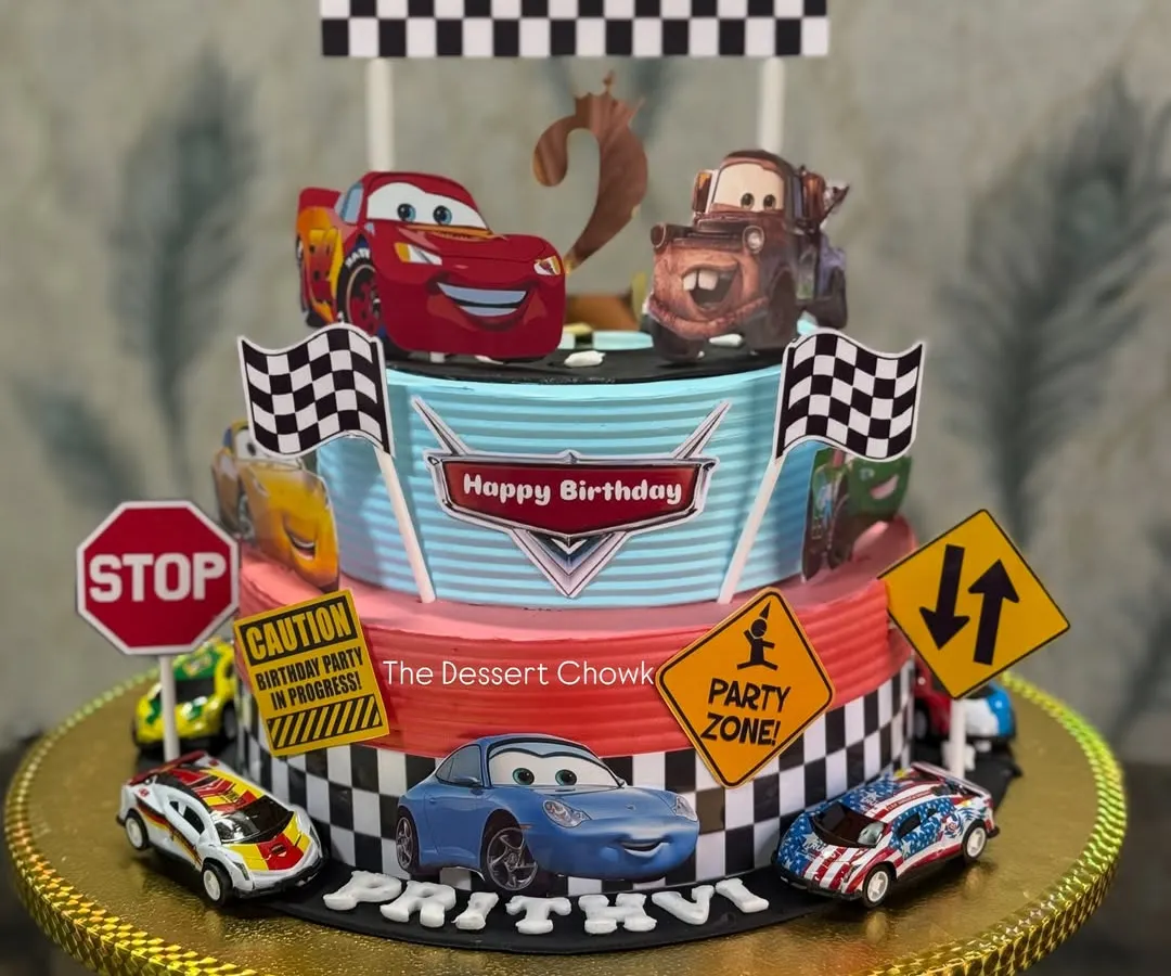One of my most popular designs for kids' birthdays. This two-tier Lightning McQueen cake brings the race track to the party, complete with all the favorite characters. This one was made with my special Royal Rasmalai flavour.