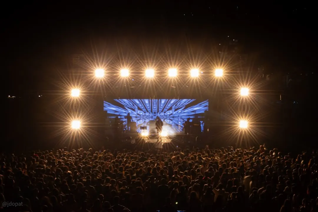 Capturing the full scale of a live event, this shot shows the entire stage setup for Amit Mishra's concert, with dramatic lighting and the energy of the audience.