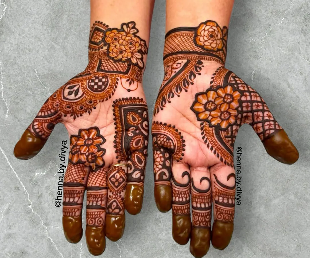This is a full-palm design that combines intricate floral work with classic paisley and geometric elements. It's a rich, dense pattern that is perfect for close family members or anyone wanting a statement look for a festival or wedding.