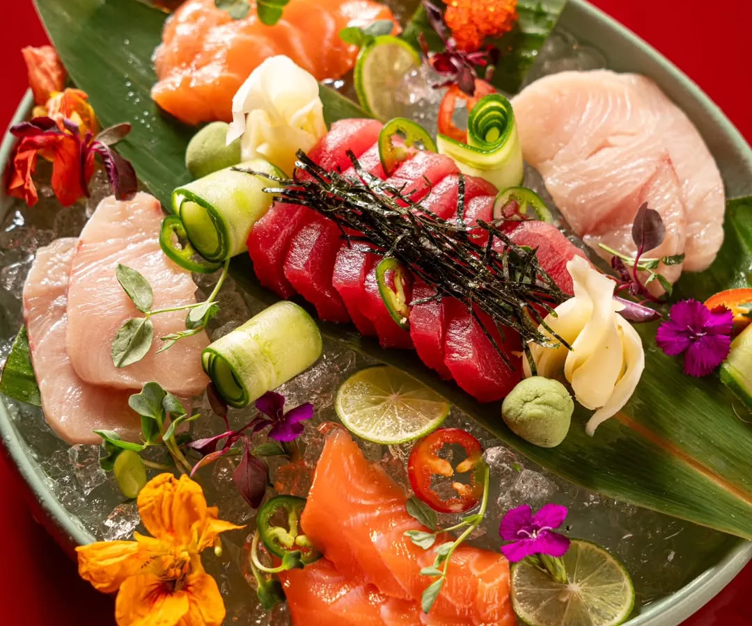 This shot demonstrates our expertise in high-end food styling and photography. We meticulously arranged this vibrant sashimi platter on a bed of ice with edible flowers to create a visually stunning image for a fine-dining Asian restaurant.