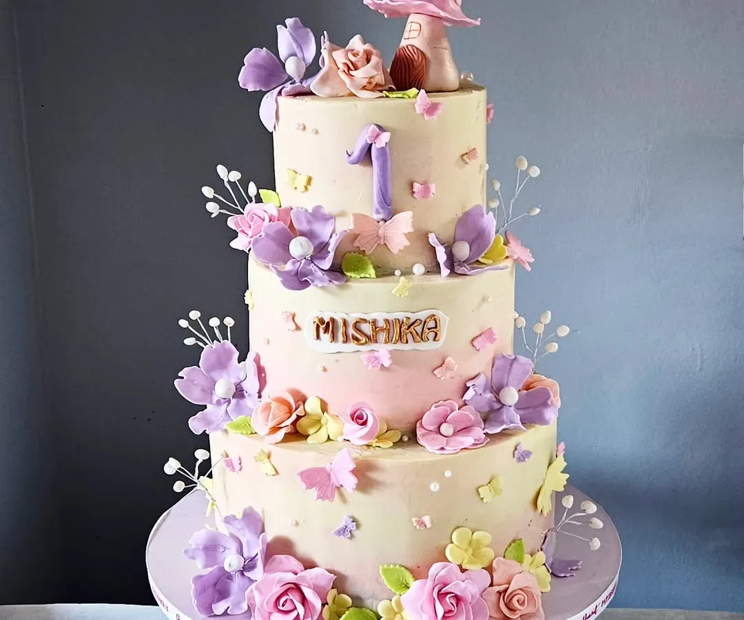 I designed this three-tier enchanting garden cake entirely without fondant, using delicate pastel tones and hand-sculpted flowers. It's a perfect example of how I can create a whimsical, multi-layered masterpiece that remains light and creamy.
