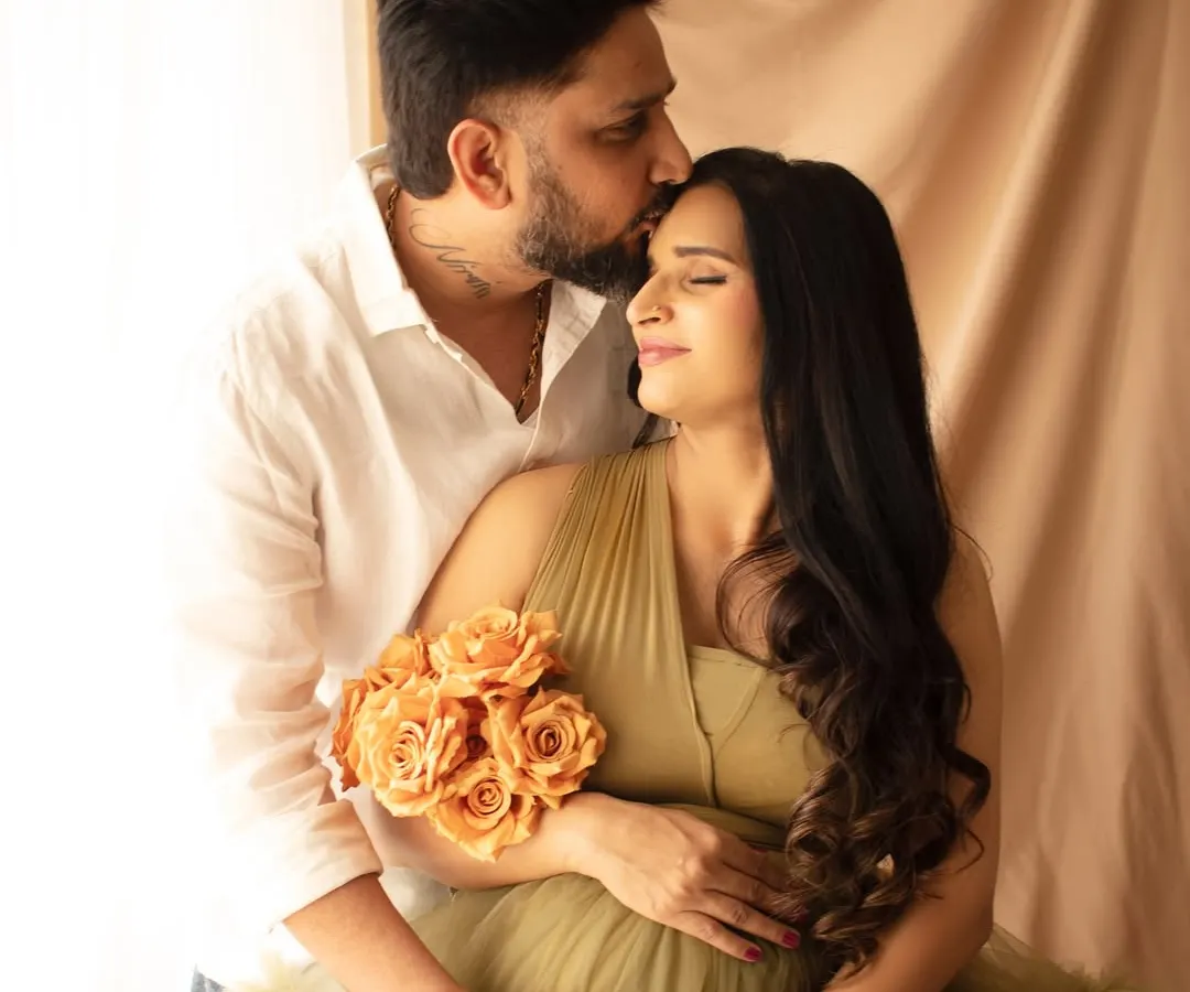 An intimate moment between partners. A gentle kiss on the forehead speaks volumes, capturing the love and support that surrounds this new chapter.