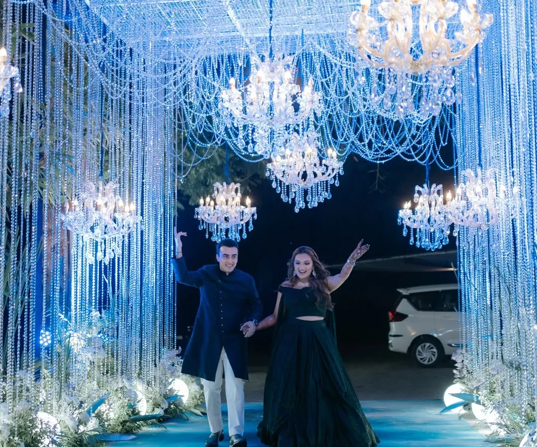 The entrance to an unforgettable night. We designed this tunnel of cascading crystals and chandeliers to create a dramatic, immersive welcome for the couple, setting the tone for a Sangeet that was pure magic.