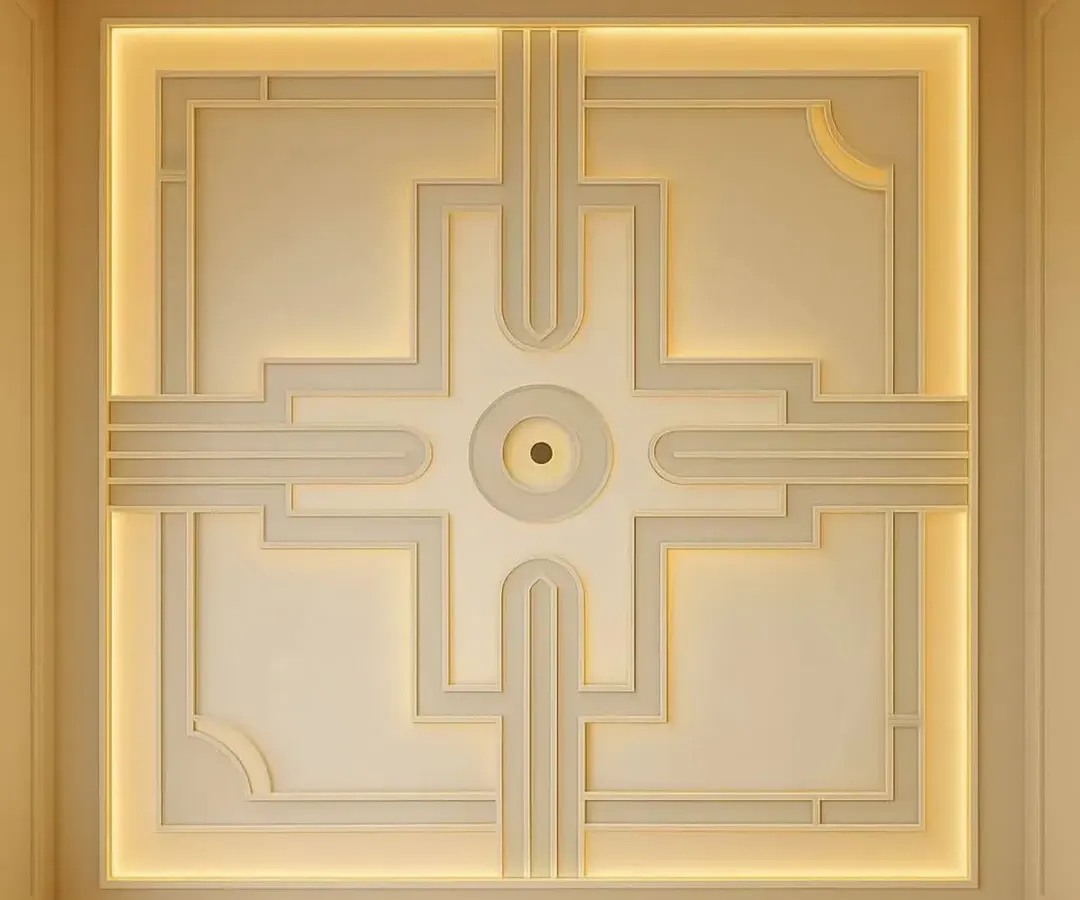 A perfect example of a modern, elegant false ceiling. This design uses clean geometric lines and warm, hidden cove lighting to give the room a sophisticated feel without being overpowering.