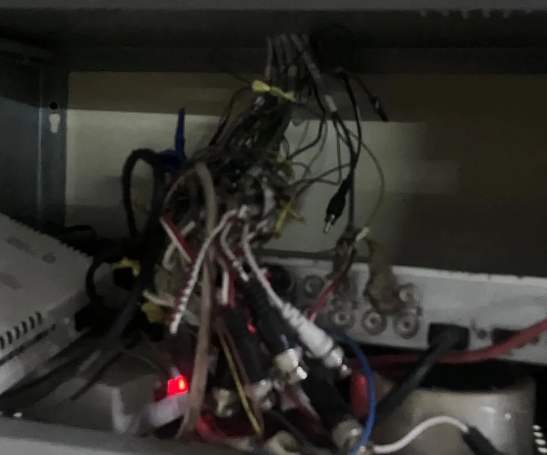 This is what we often find: a tangled mess of wires behind a DVR. This kind of setup is a fire hazard and the main reason for system failures, blurry footage, and recording gaps.