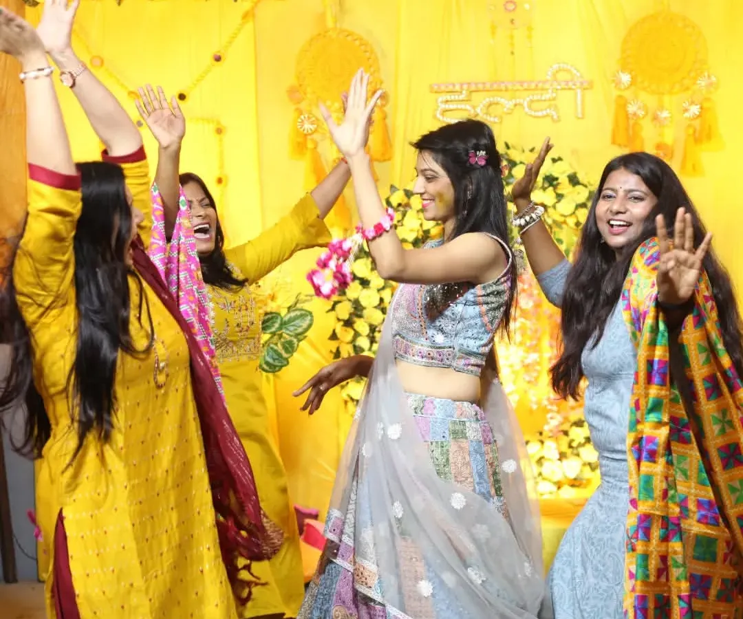 The pure energy of a Haldi ceremony, with the bride and her friends dancing without a care. We love capturing these high-energy, unposed moments of celebration that show the true spirit of Indian weddings.