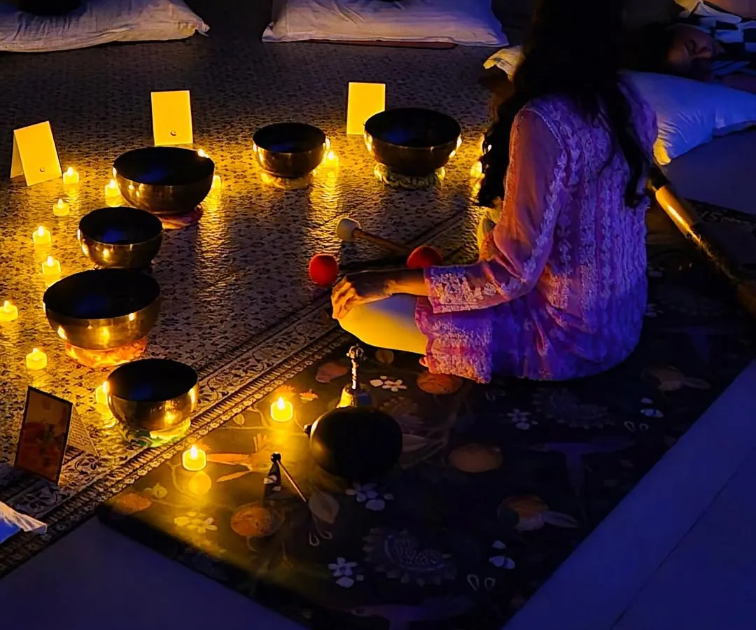 This is what my group sound bath sessions look like. Participants lie back and let the resonant frequencies of the singing bowls wash over them, melting away tension in a candlelit, tranquil environment.