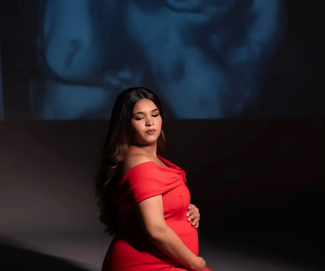 In the quiet of the studio, we projected her baby's sonogram, the very first picture, onto the wall. It’s a powerful and deeply personal way I help mothers connect with the little life they are nurturing. This is more than a portrait; it's a conversation before the first hello.
