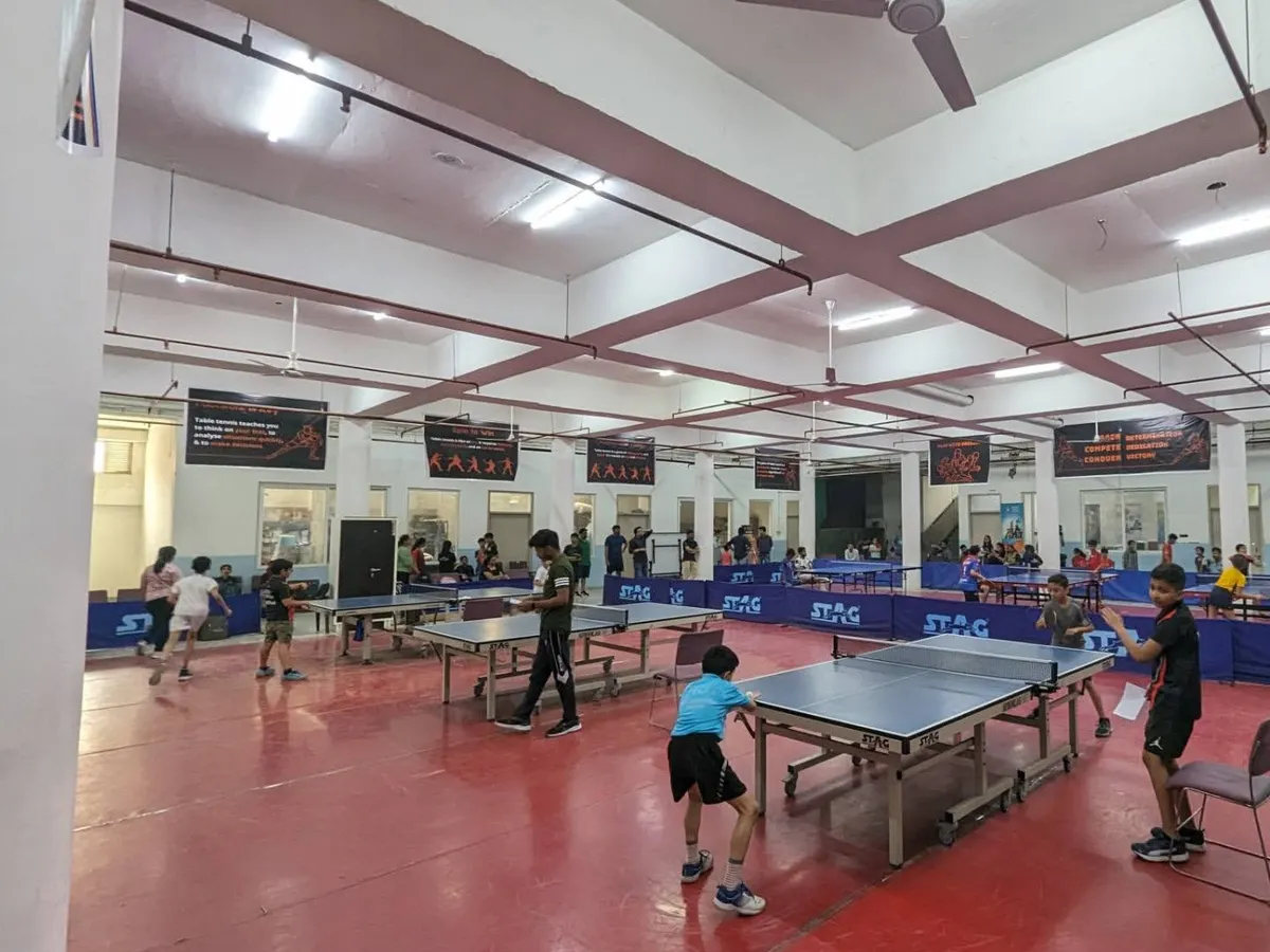 A view of our tournament hall in full swing. I ensure a professional setup with multiple STAG tables, proper flooring, and excellent lighting, creating the perfect arena for serious competition.