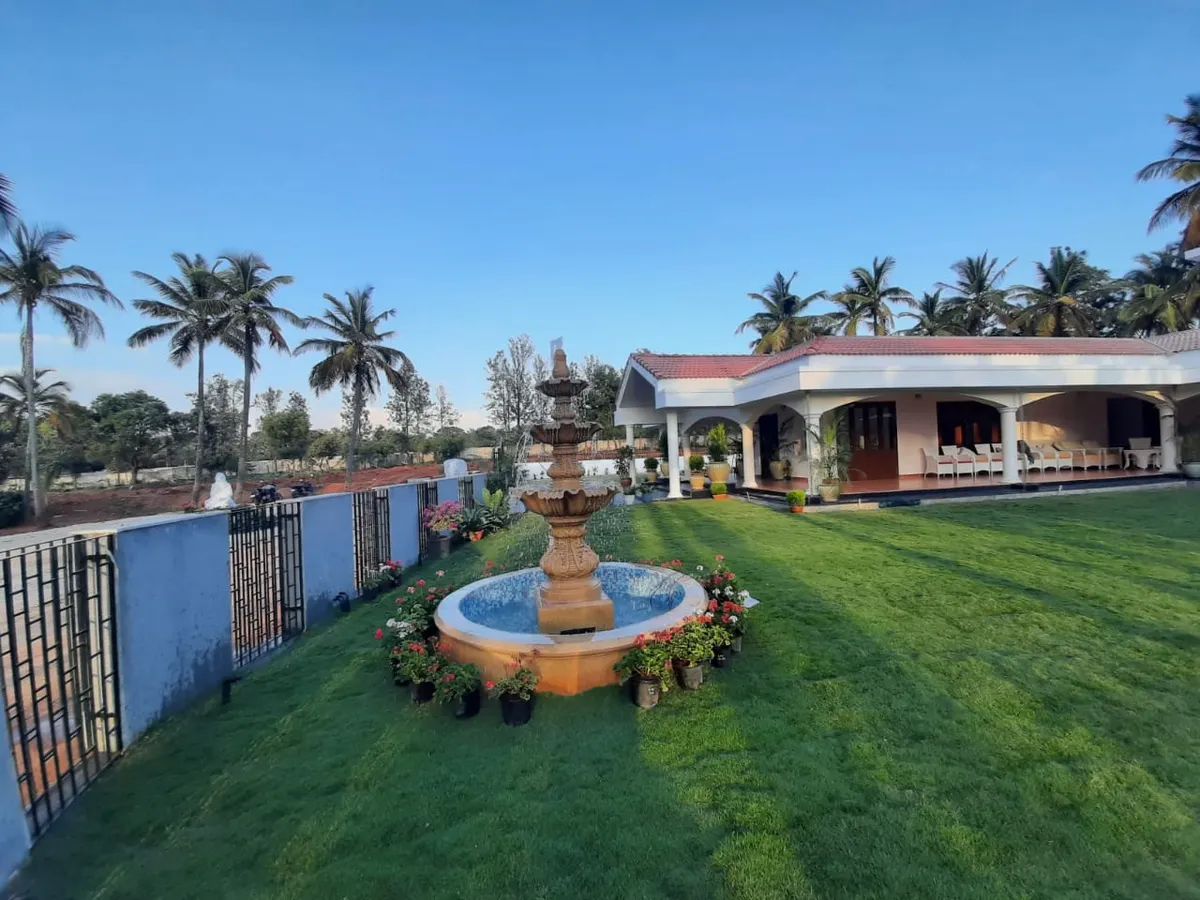 A sprawling residential property featuring a lush lawn, mature palm trees, and a classic tiered water fountain as the centerpiece. This project showcases my capability in executing large-scale landscape designs that include both softscaping and hardscaping elements.