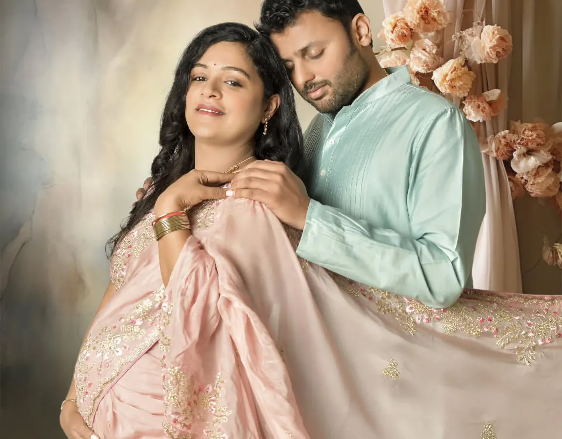 I believe in capturing the shared joy of this journey. This portrait shows a serene moment between partners, styled with a beautiful traditional saree to create a soft, painterly memory of their love and anticipation.