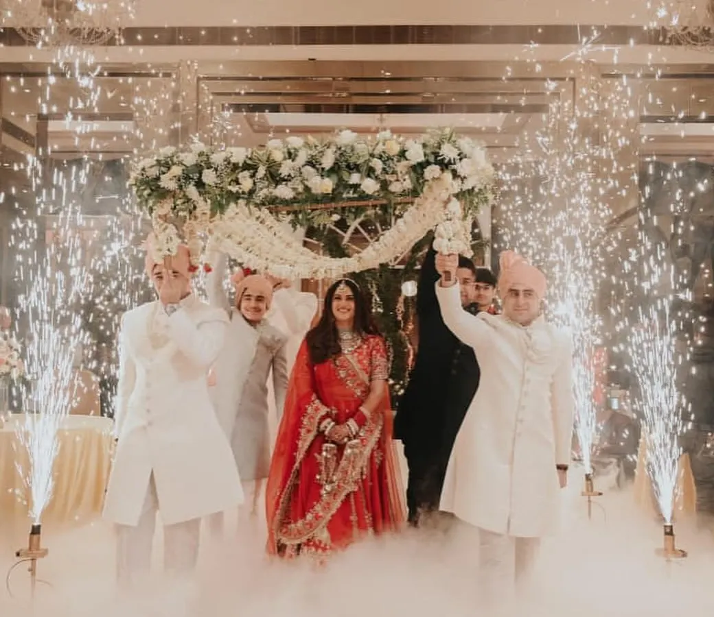 A bride's entrance is a moment of pure magic. I focus on capturing the grandeur of the celebration, with the dramatic cold pyrotechnics and fog creating a pathway for her as she walks towards her new beginning.