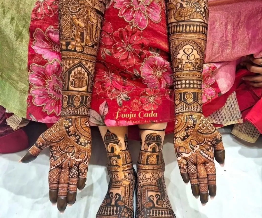 A complete bridal look is essential. Here you can see how I coordinate intricate designs for both the hands and feet, featuring traditional elephant motifs and detailed patterns that extend up the arms and legs.