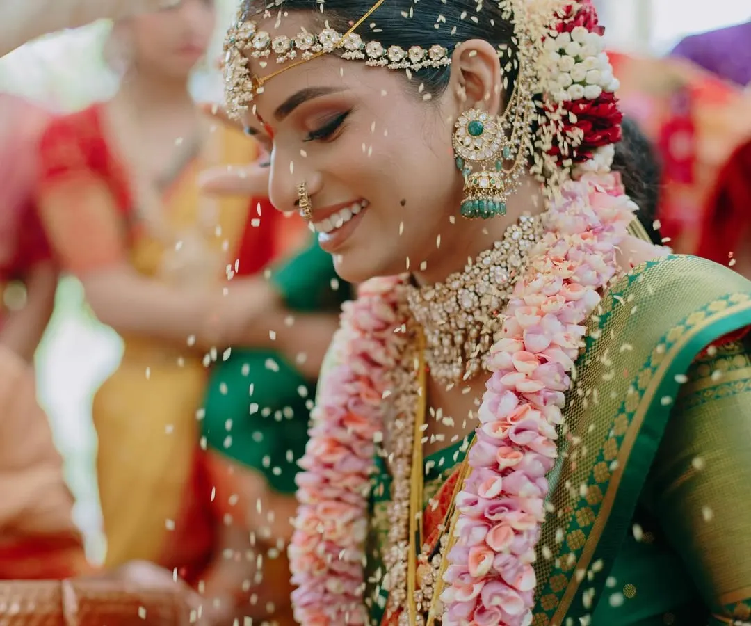 The pure joy of a wedding ceremony. This candid moment captures my South Indian bride, Meghna, during her Mahuratham in Coorg. Her makeup was designed to be luminous and long-lasting, with defined eyes that sparkle with happiness, even through the most emotional rituals.