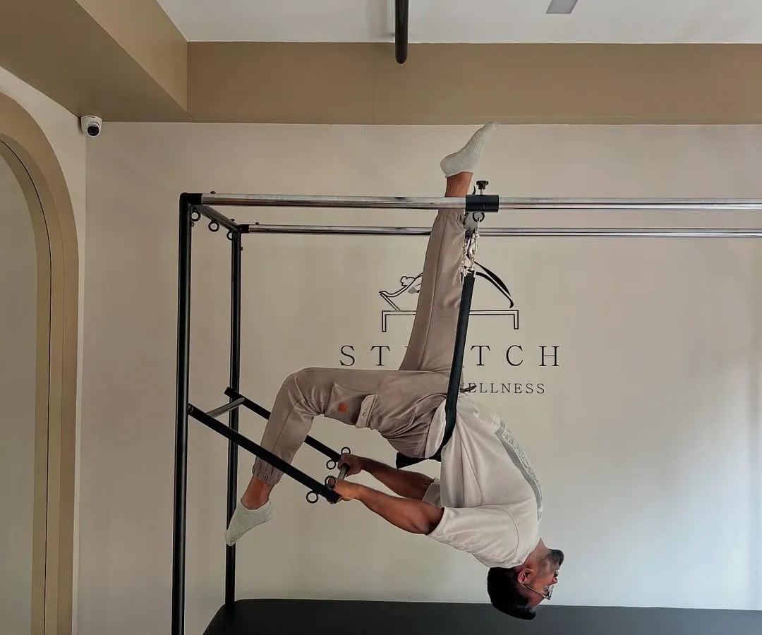 This is what happens when strength meets control. Using the Pilates Cadillac, I help you challenge your core and master your body's potential. This level of inverted strength and flexibility is possible with consistent, guided practice.