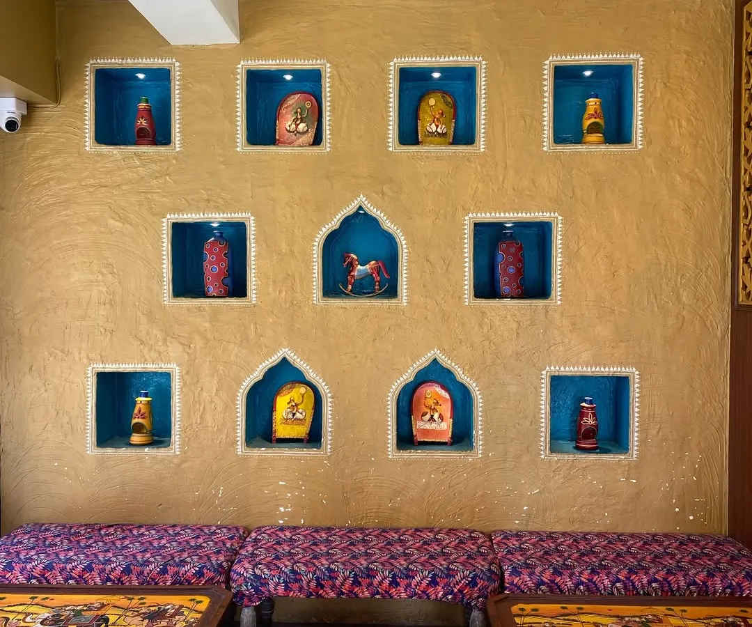 For this project, I brought a traditional Indian vibe to a modern eatery. The textured mud wall is highlighted by hand-painted niches, each telling a small story and creating a warm, inviting atmosphere for guests.