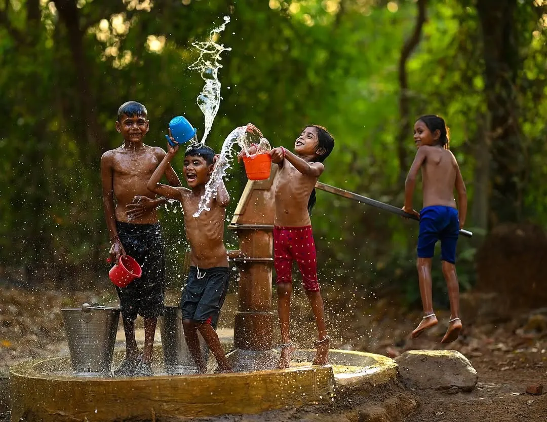 The pure energy of a village summer, frozen in time. This shot from my "Childhood Summers" series captures the simple, uninhibited happiness of kids playing near a handpump in rural Maharashtra.