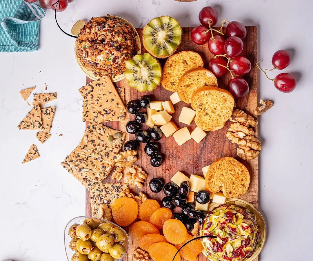 A glimpse of our signature cheese platters, where it all began. This board features two of our handcrafted truffle cheese domes, the Truffle & Shiitake Mushroom and the Truffle, Pistachio & Cranberry, paired with artisanal crackers, fresh fruits, and nuts for a perfect gourmet experience.