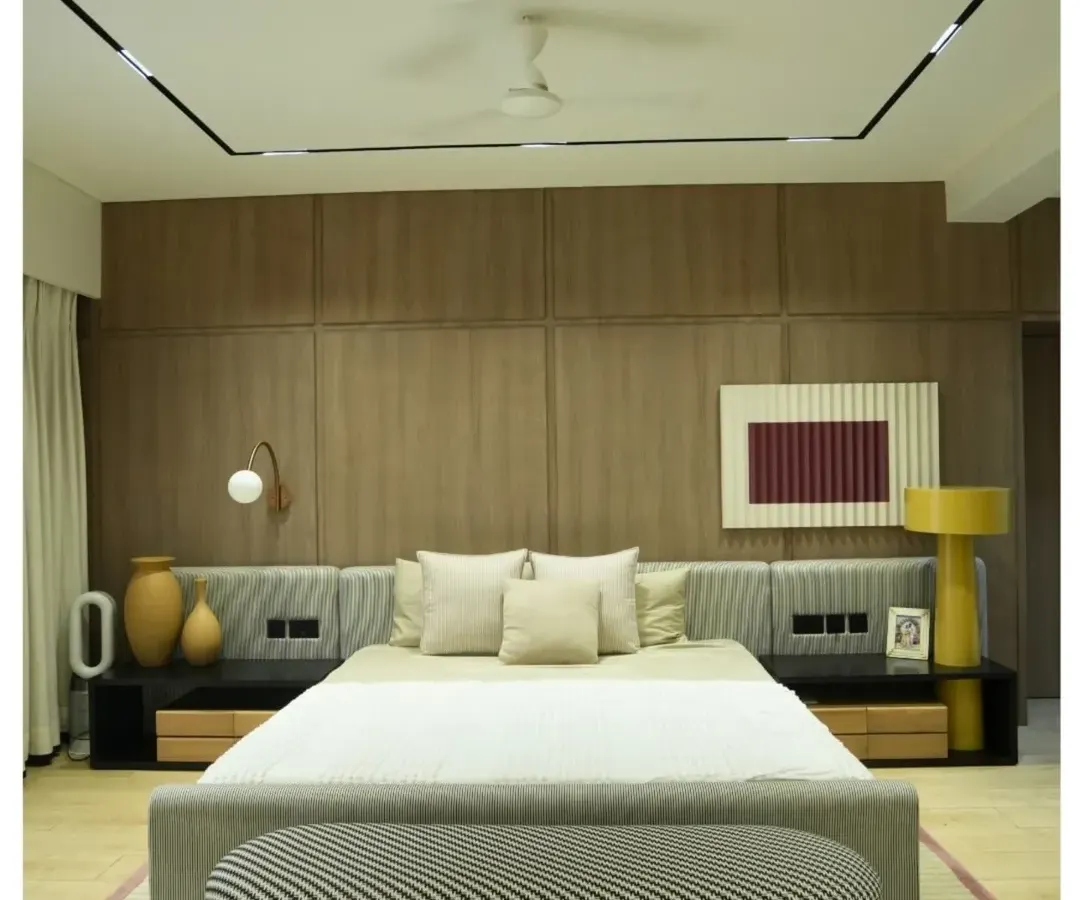 This is what I call a master suite. From the custom wood-paneled feature wall and integrated bedside lighting to the plush, comfortable furnishings, every detail in this penthouse bedroom is crafted for ultimate relaxation and style.