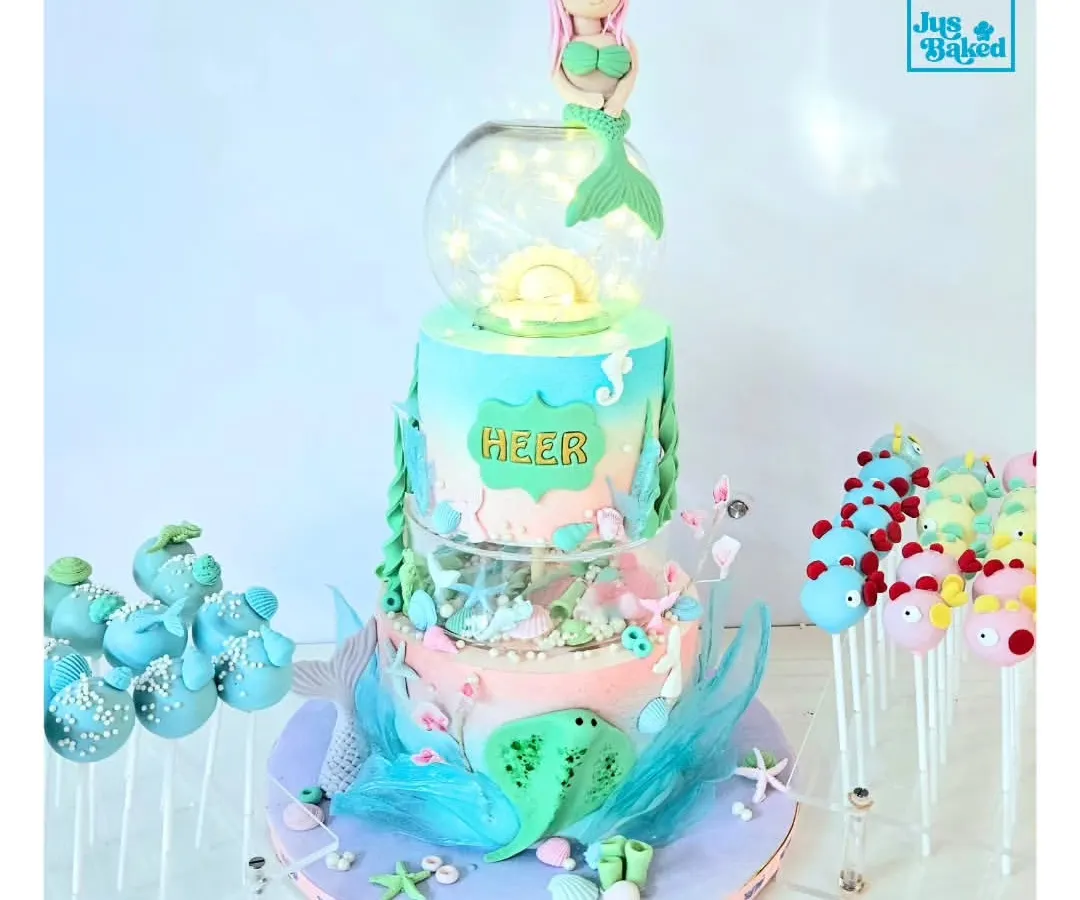 This three-tier mermaid cake is a perfect example of how I bring fairytales to life. It features ocean-inspired colors, edible sea creatures, and even fairy lights to create a magical underwater world for a special birthday.