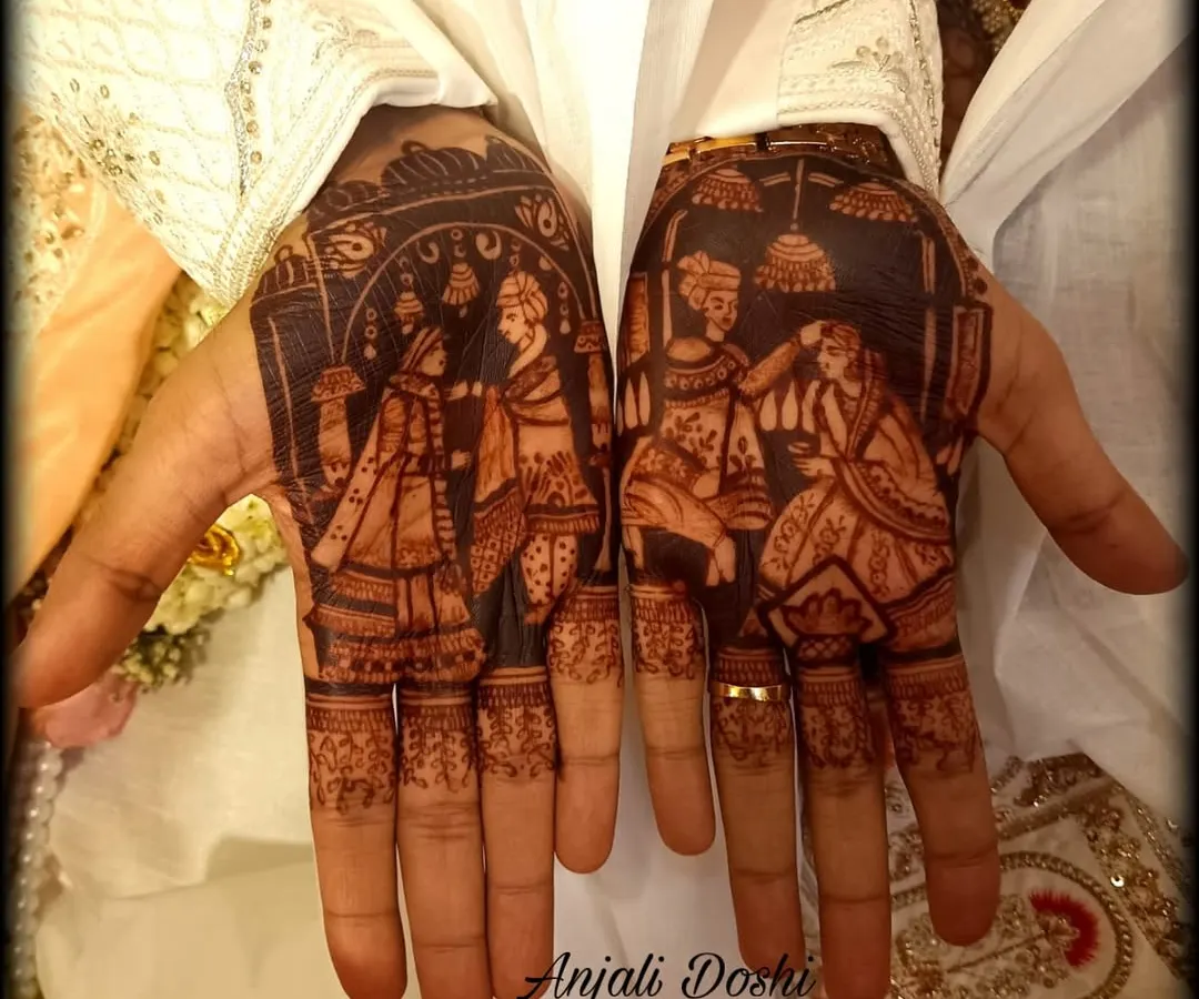 I love when grooms want to tell their story. This detailed portrait mehendi shows the varmala ceremony, creating a beautiful and personal piece of art for the groom's hands. The dark stain makes the figures pop.