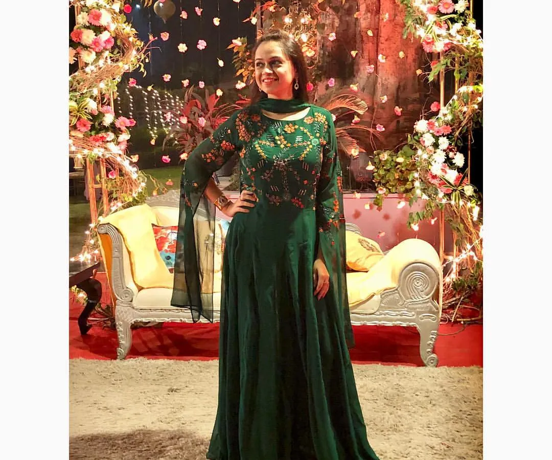 This elegant emerald green Anarkali gown is perfect for a wedding reception or sangeet. I chose this piece for its stunning color and trendy playful sleeves, which add a modern twist to a classic silhouette.