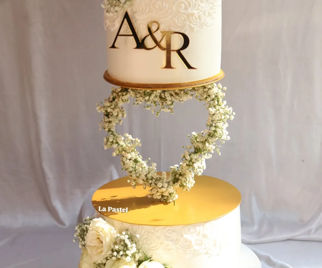 I love creating dramatic, multi-tiered cakes for big celebrations. This engagement cake features a floating heart made of delicate baby's breath, connecting two tiers for a truly magical effect. It's a perfect centerpiece for a modern romance.