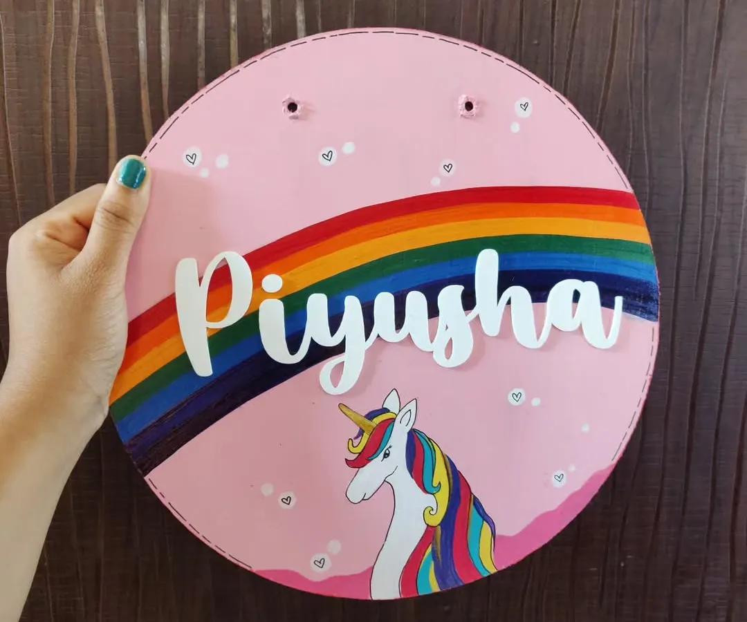 I love creating these custom unicorn-themed nameplates for kids' rooms. Hand-painted on a sturdy wooden base, this piece for Piyusha features a vibrant rainbow and a magical unicorn, bringing a touch of personalized joy to a child's door.