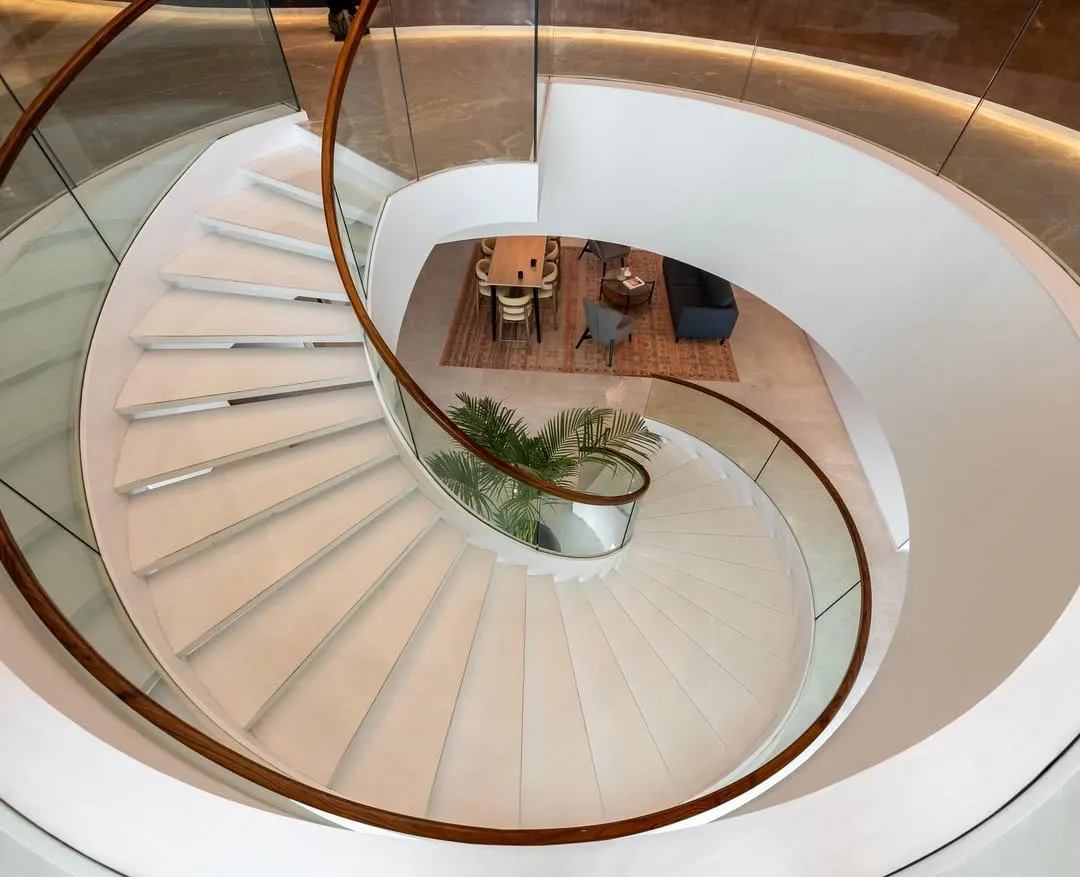 The sculptural spiral staircase at the Asian Paints headquarters serves as a central connecting element, embodying the brand's commitment to design and innovation. It is more than a means of circulation; it is a statement piece that anchors the executive floors.