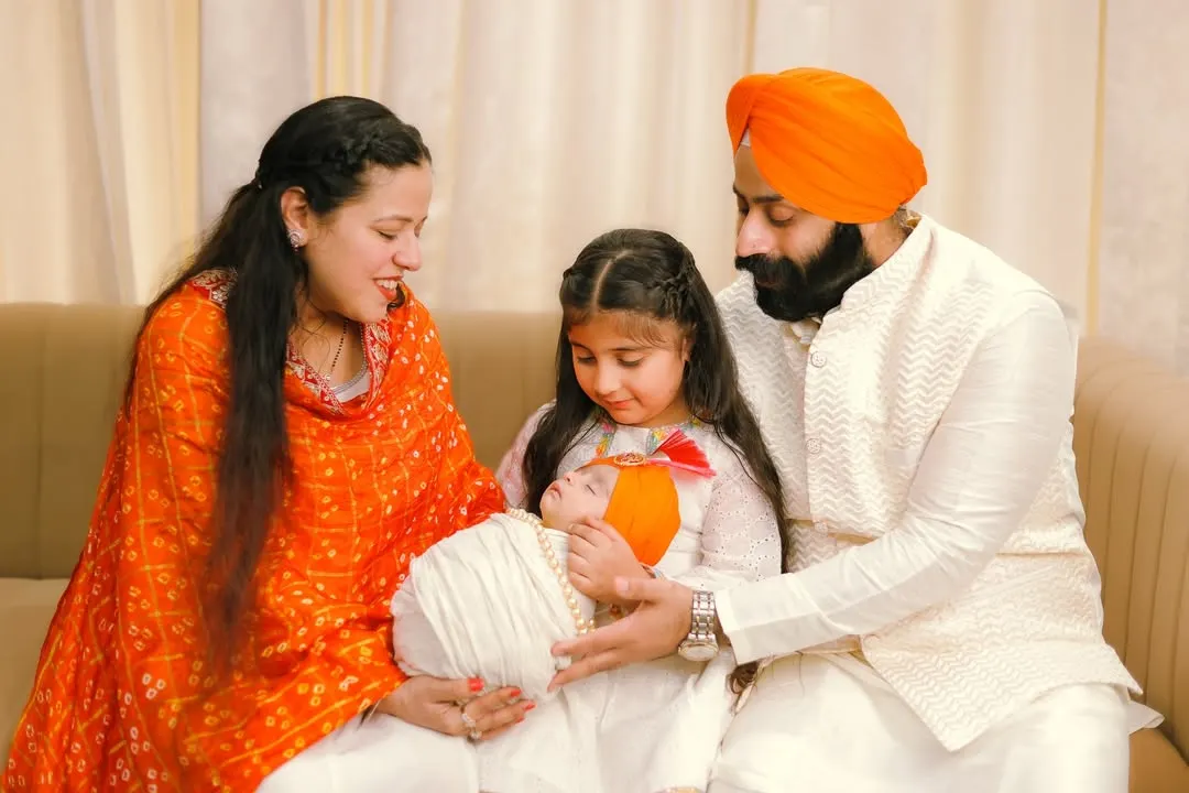 A family made whole, blessed with a new arrival. I was honored to capture this beautiful Sikh family as the older sister meets her newborn sibling for the first time, all dressed in vibrant, traditional attire. These are the quiet, sacred moments of connection.