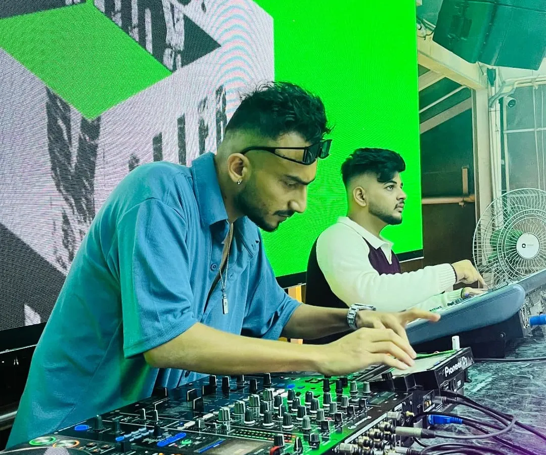 Focused in the zone, crafting the perfect set. I use a Pioneer DJ setup to precisely mix and layer tracks, ensuring a seamless flow of energy all night long.