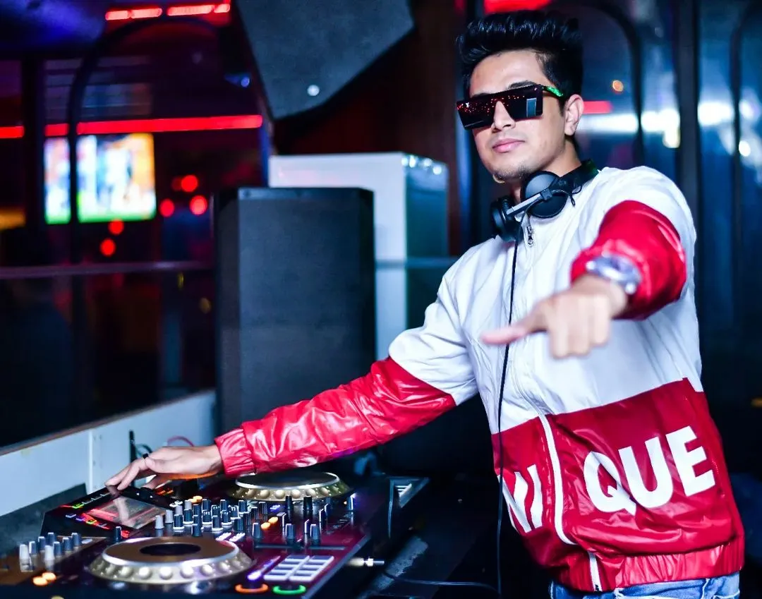Behind the decks is where I belong. This is a shot of me in my element, focused on the music and the crowd's energy. I bring a professional setup and a stylish presence to every gig.
