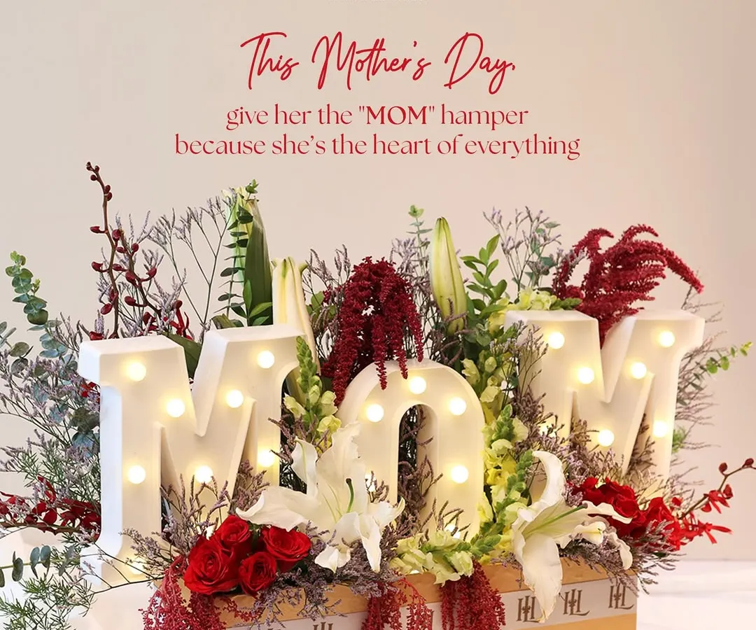 For Mother's Day, I wanted to create something that literally spells out love. This statement hamper features illuminated 'MOM' letters nestled in a bed of fresh, vibrant florals, making it a tribute to her love, strength, and magic.