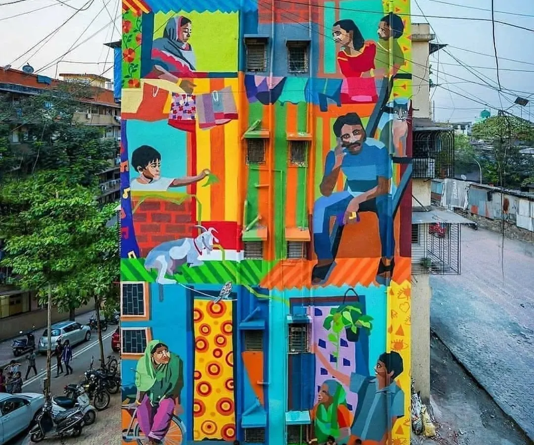 This vibrant, multi-story mural titled "Me/We" captures the spirit of community in Mumbai. It's a colorful depiction of daily life, showing different families and individuals coexisting in a single building, a true reflection of the city's soul.